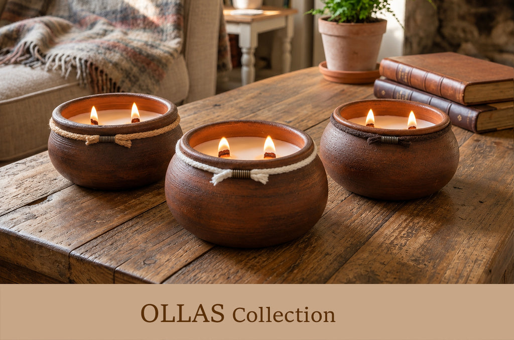 Three rustic brown clay candles in round pots with white rope accents, lit and displayed on a wooden table in a cozy living room setting. A banner at the bottom reads 'OLLAS Collection'.